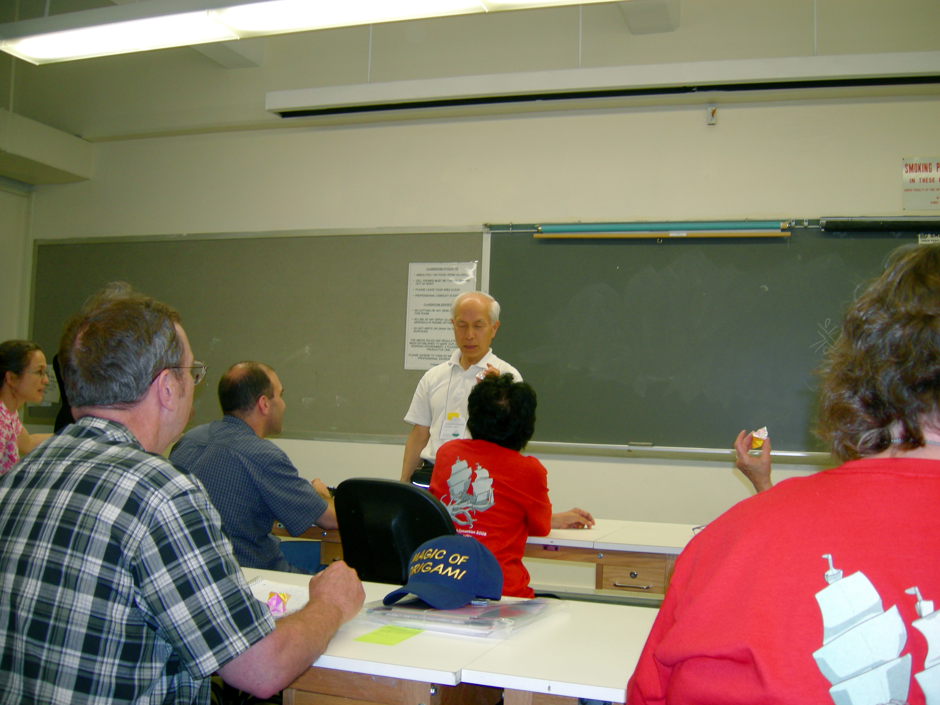 Susumu Nakajima in front of the classroom.