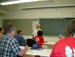 Susumu Nakajima in front of the classroom.