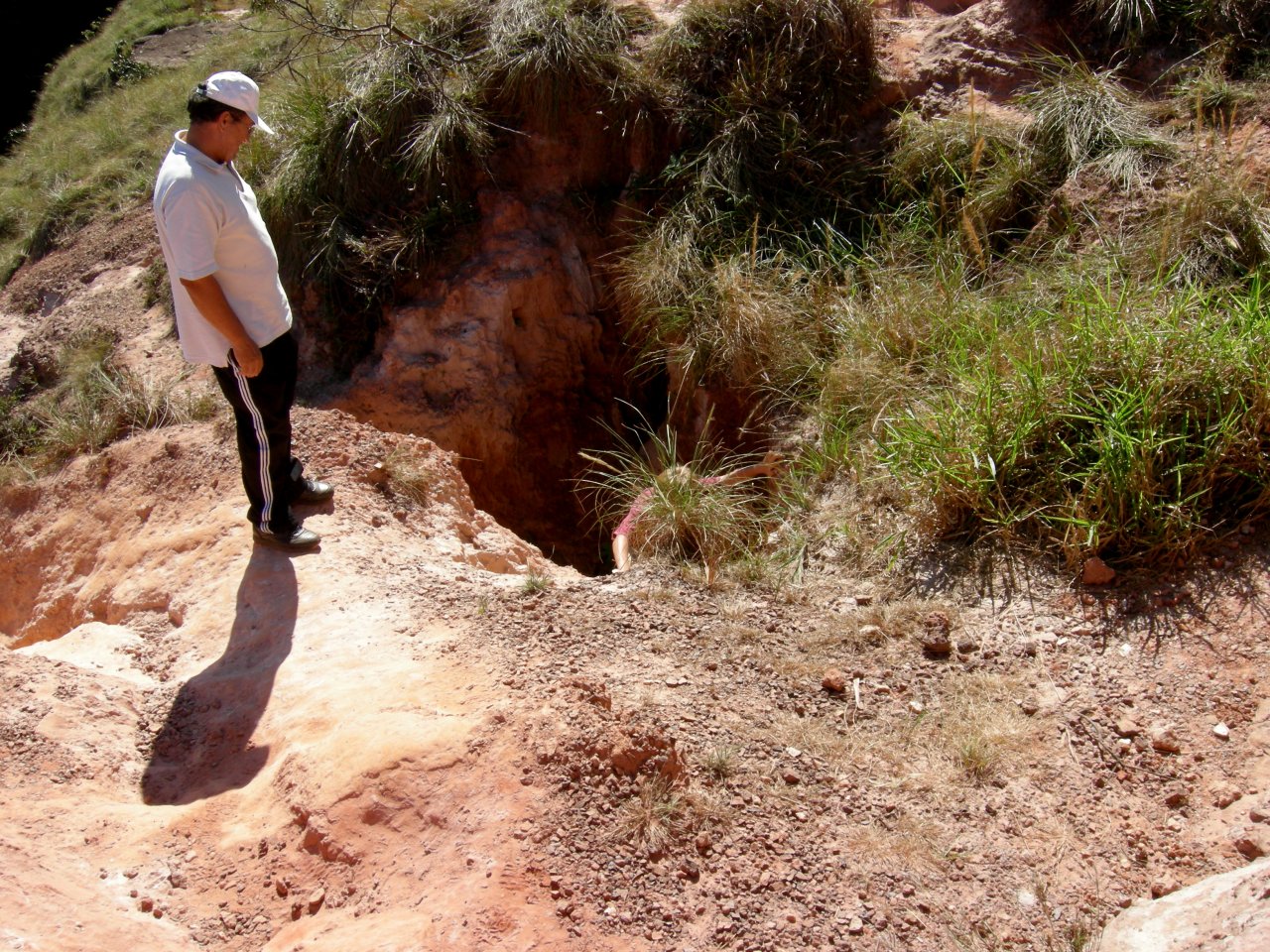 Matthew climbing out of a hole