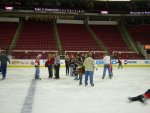 a big group of folks congregating in the center of the ice