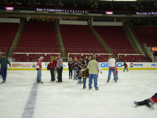 a big group of folks congregating in the center of the ice