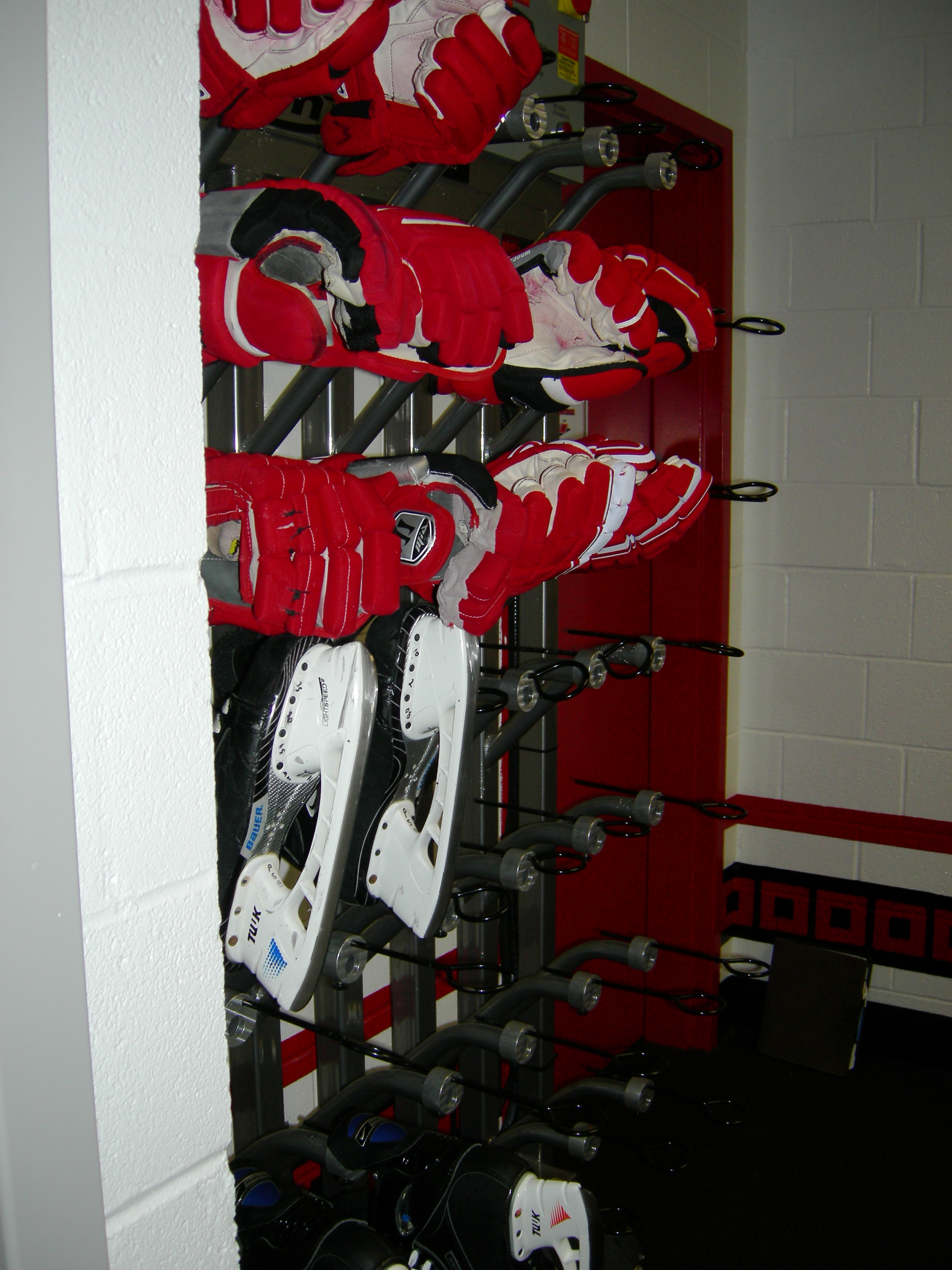 Gloves and skate warmers near the entrance to the bench.