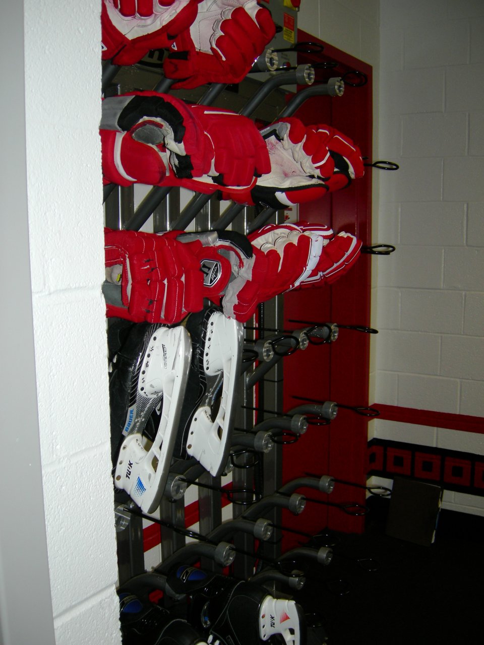 Gloves and skate warmers near the entrance to the bench.