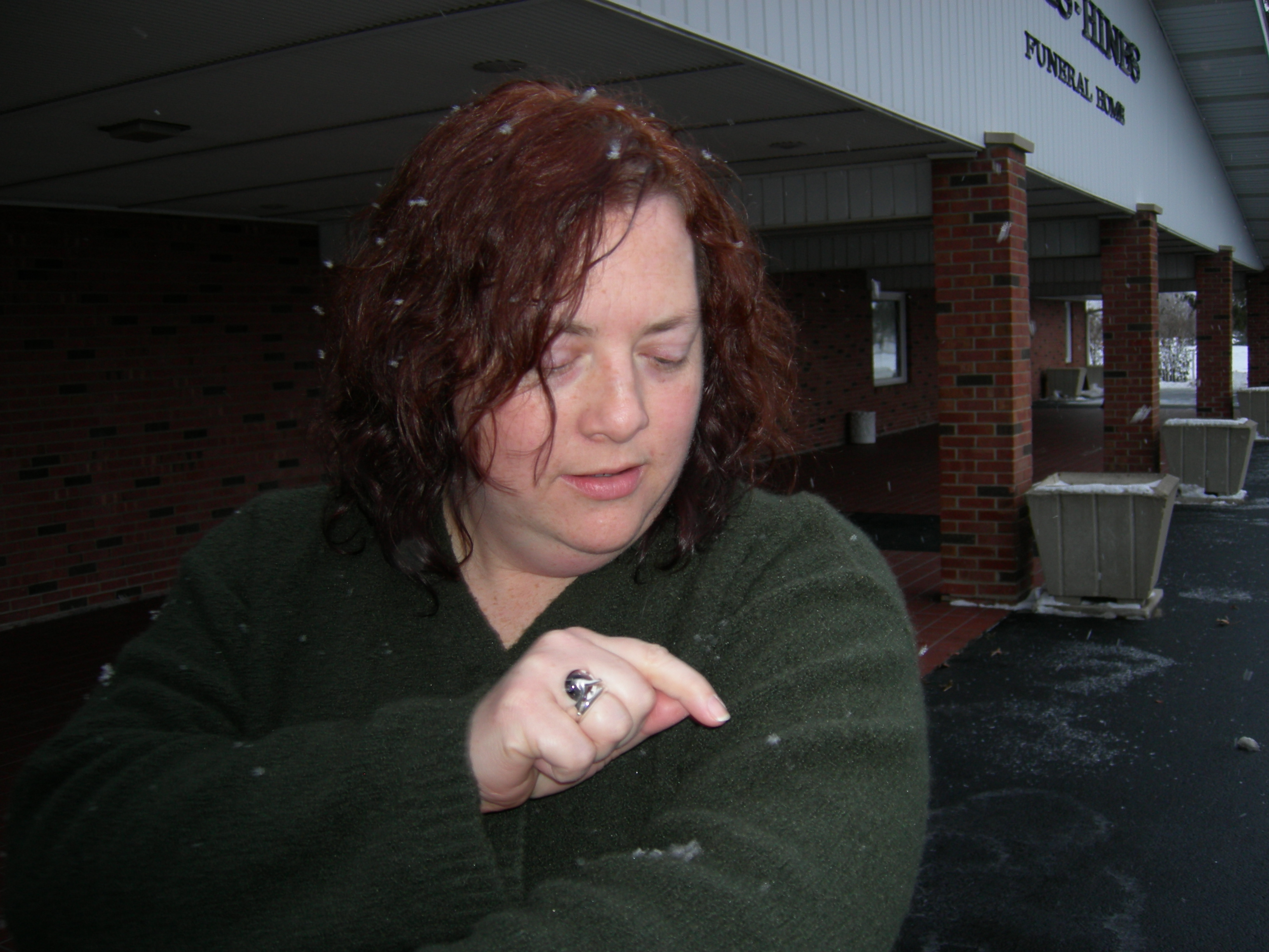 Cynthia pointing out the snowflakes on her sweater.