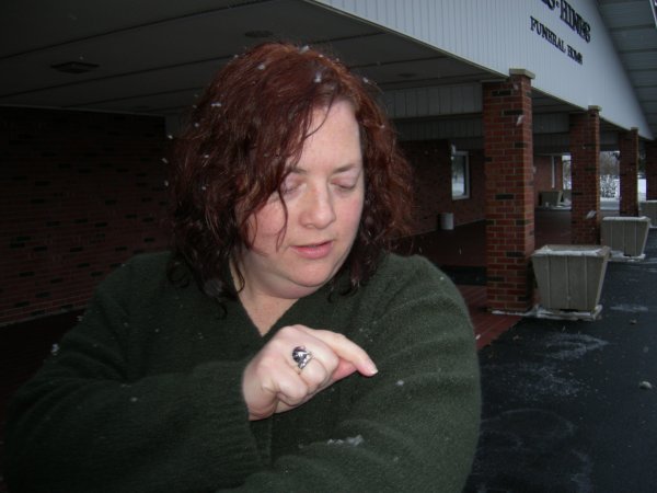 Cynthia pointing out the snowflakes on her sweater.