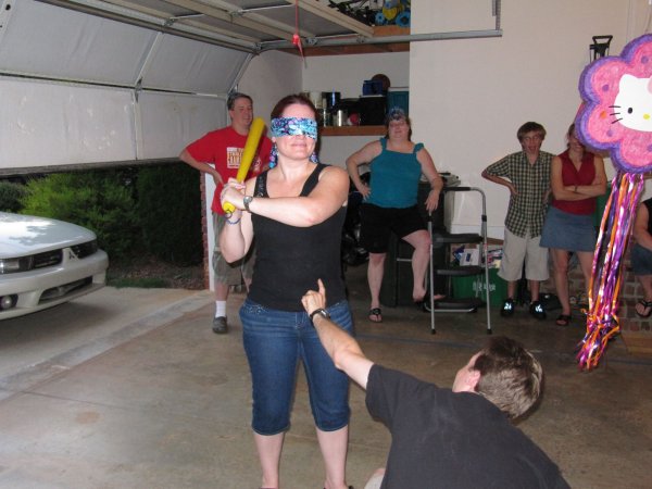 Tim is poking Kelley when she can't see