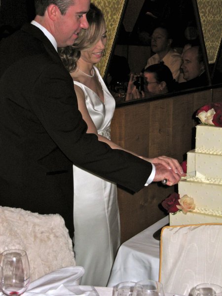 Chris and Courtney cutting the cake
