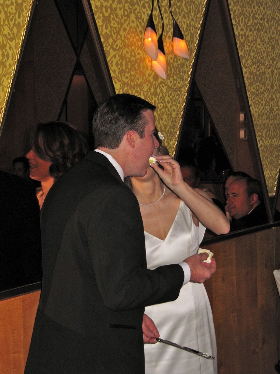 Courtney feeding cake to Chris