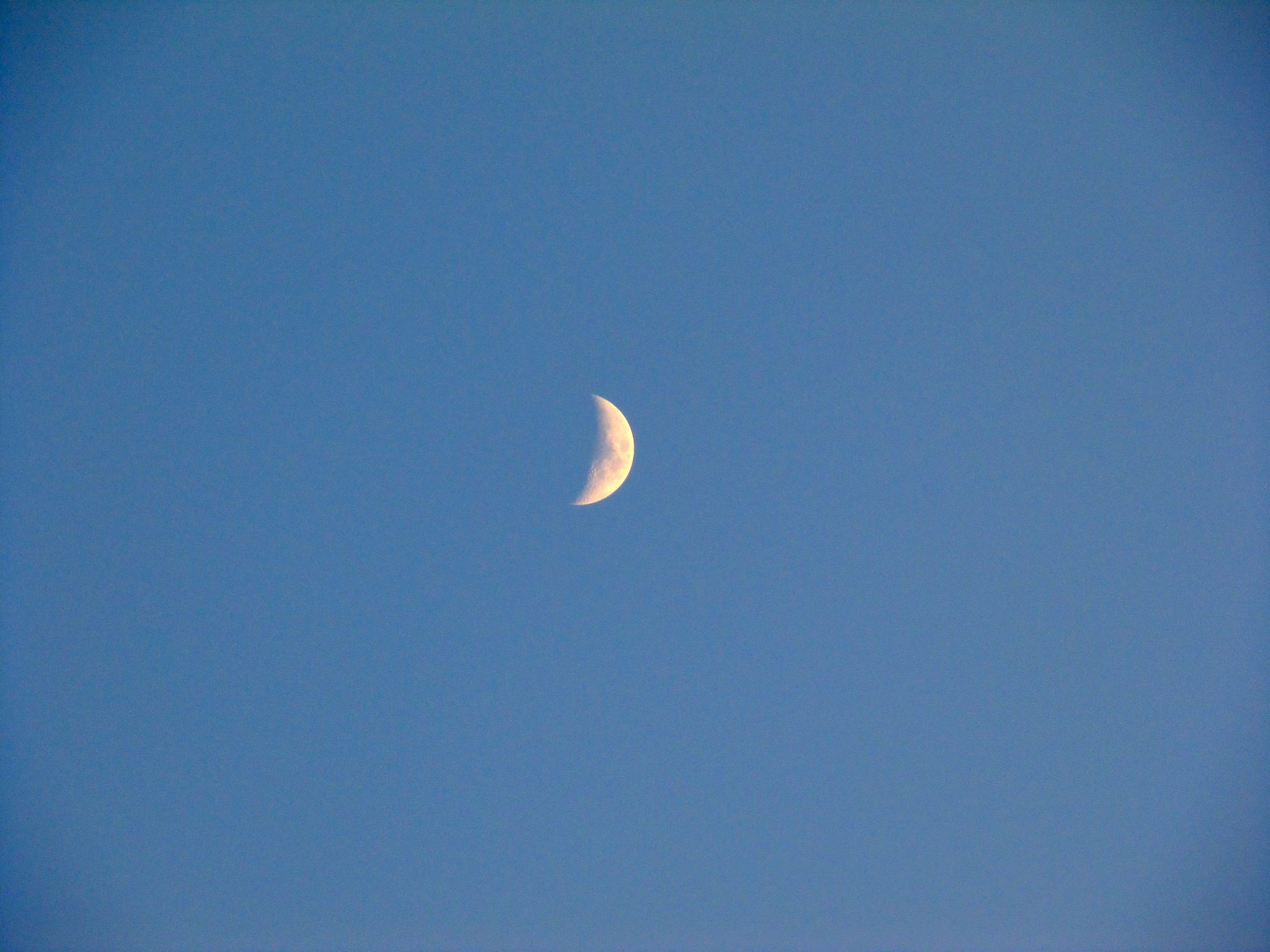 the sun is setting, the moon is up