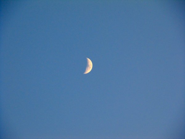 the sun is setting, the moon is up