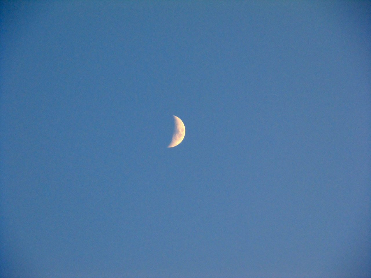 the sun is setting, the moon is up