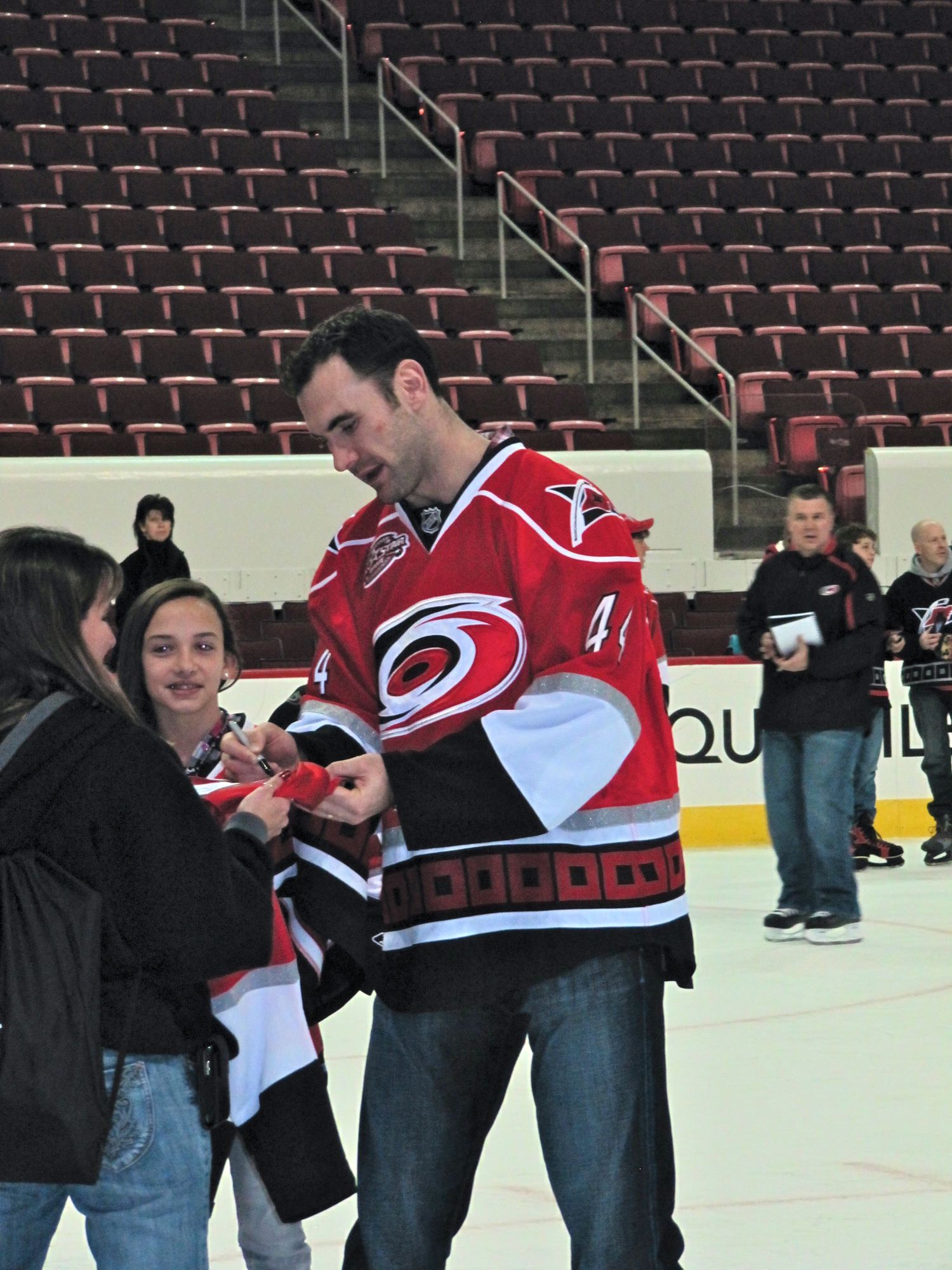 Jay Harrison signing autographs on the ice