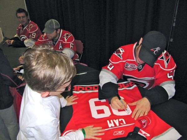 LaRose signing Cameron's jersey