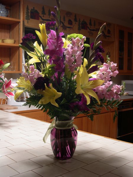 purple gladiolas and snap dragons, and yellow lilies