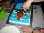 Aaaargh!  My head!  (Cutting the cake.)